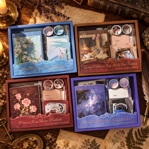 Four Starry Dream collage journal kits displayed on an antique writing desk with candlelight and dried botanicals